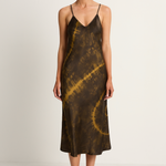 Woman wearing a tie-dye slip dress on a white background