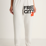 White sweatpants with 'FREE CITY' text and logo on a white background