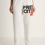 White sweatpants with 'FREE CITY' text and logo on a white background