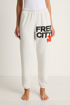 White sweatpants with 'FREE CITY' text and logo on a white background