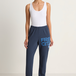 Woman wearing navy sweatpants with 'FREECITY' text on a white background