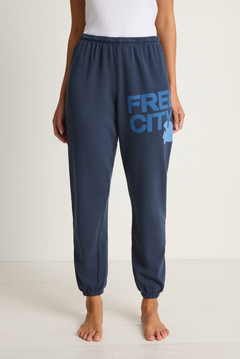 Navy sweatpants with 'FREECITY' logo worn by a person on a white background