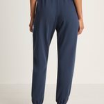 Person wearing navy blue pants on a white background