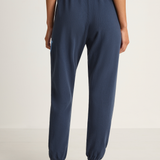 Person wearing navy blue pants on a white background