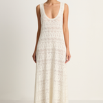 Woman wearing a white lace dress on a plain background