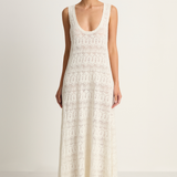 Woman wearing a white lace dress on a plain background